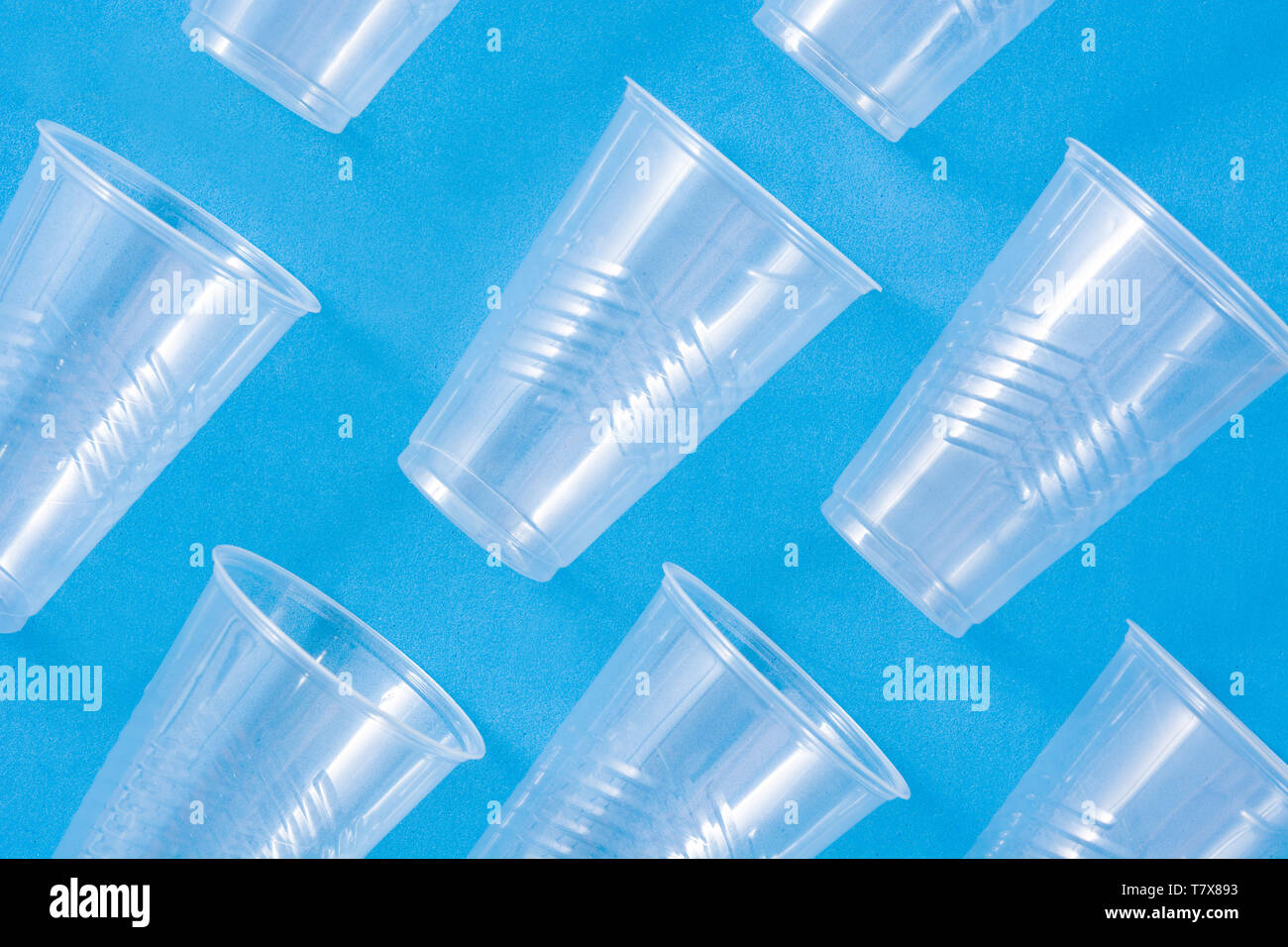 Disposable waste plastic cups pattern  on blue background Stock Photo