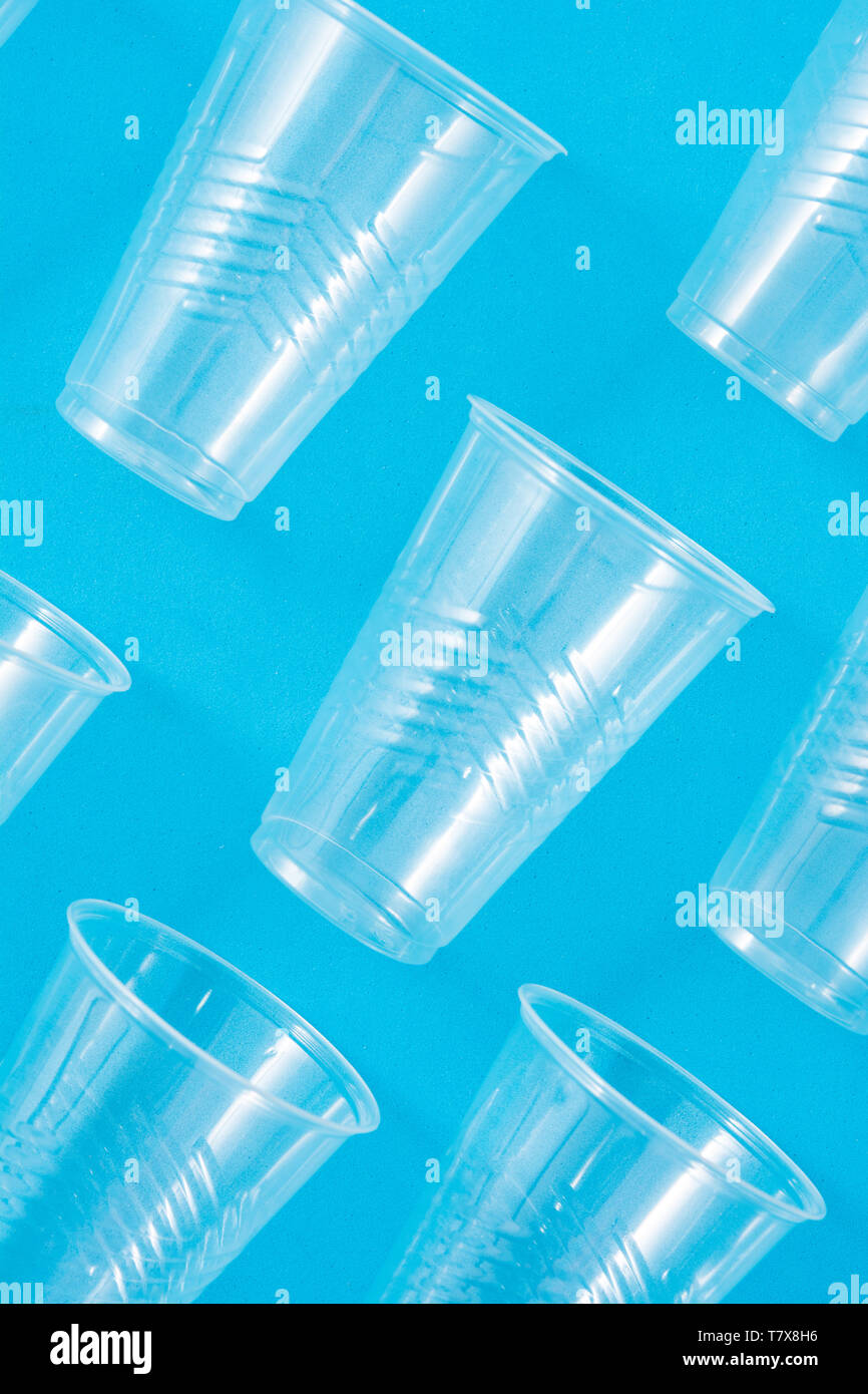 Disposable waste plastic cups pattern  on blue background Stock Photo