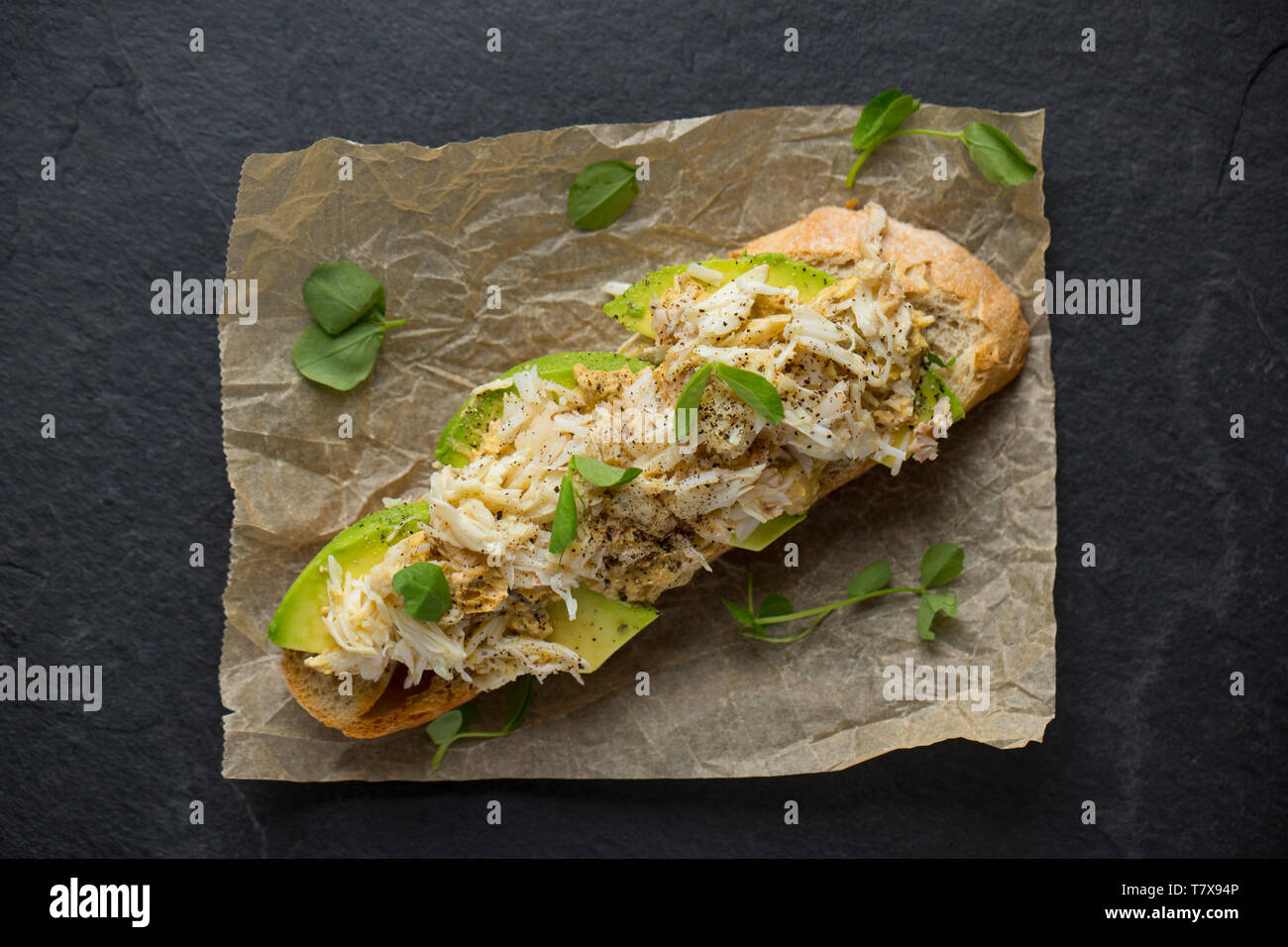 An open sandwich made from the brown and white meat of a spider crab caught in a drop net that had been lowered off a pier in Dorset. The brown meat h Stock Photo