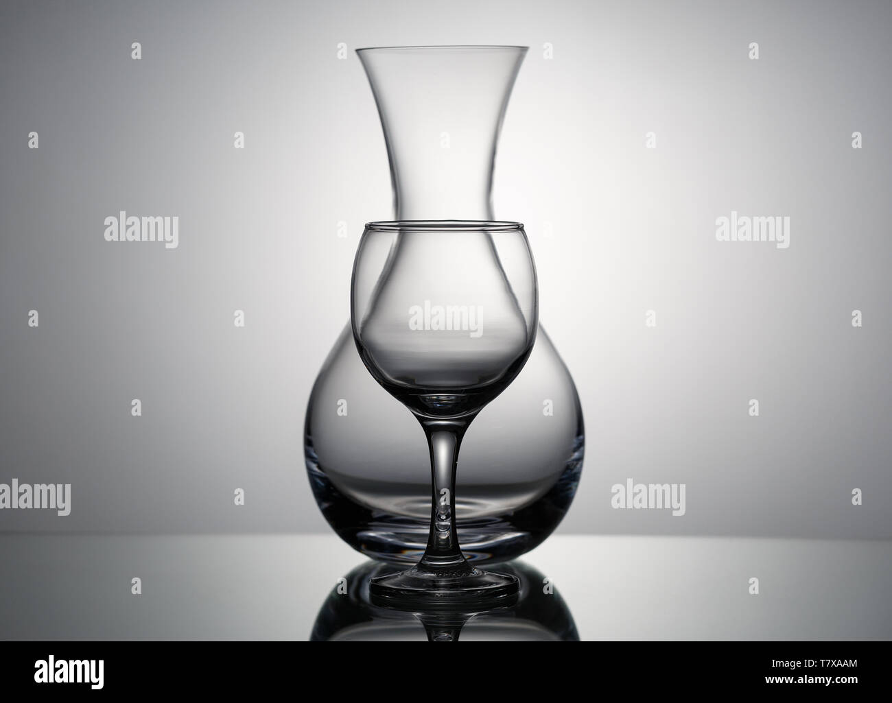 Pitcher and wine glass on grey background, silhouette on the lumen Stock Photo