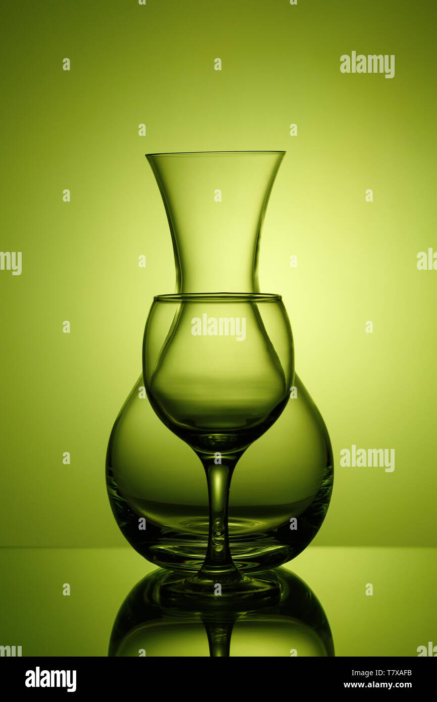 Pitcher and wine glass on green background, silhouette on the lumen Stock Photo