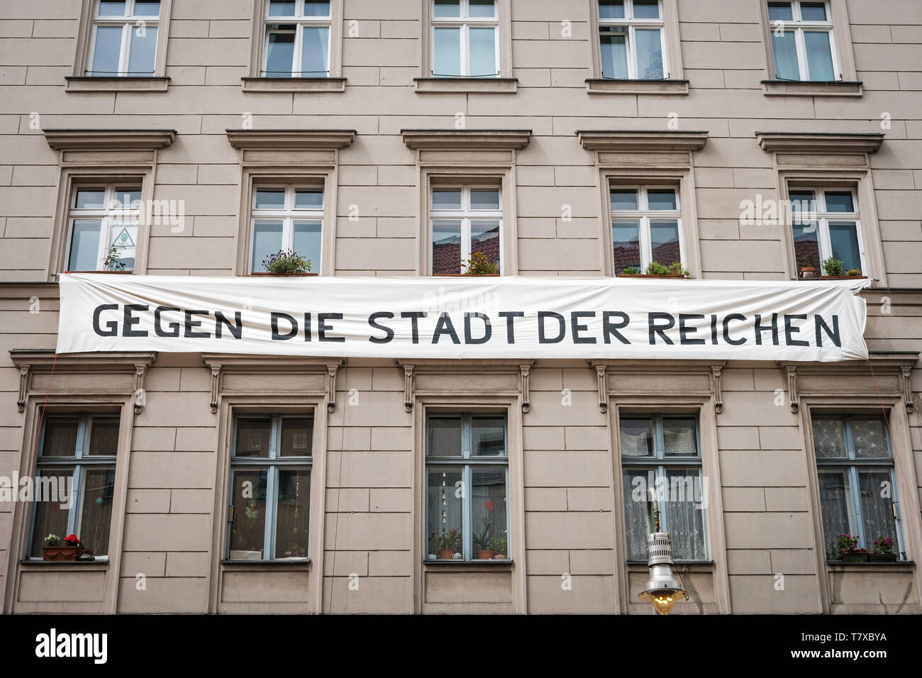 Berlin, Germany - May, 2019: Banner on house facade with political slogan against gentification in Berlin.  Against the City of the Rich (german: Gege Stock Photo
