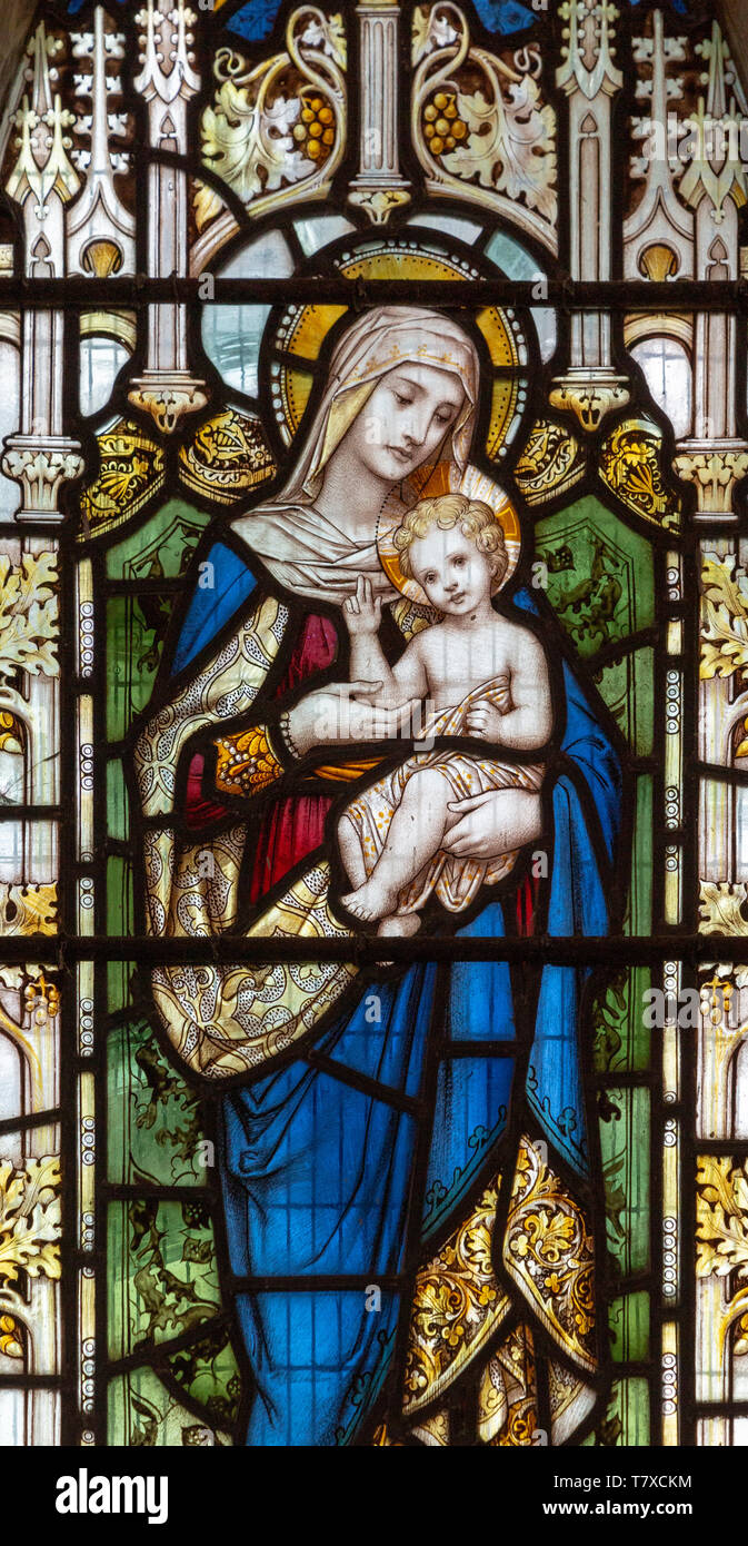 Stained glass window Blessed Virgin Mary baby infant Jesus Christ, church of Saint Andrew, Ilketshall St Andrew, Suffolk, England, UK Stock Photo