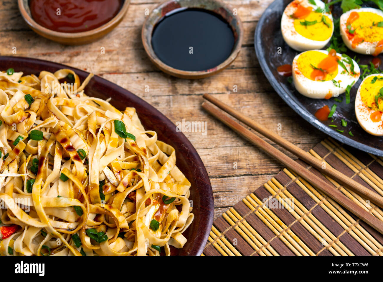 Vegetable noodles with soy sauce and ketchup tabletop view Stock Photo