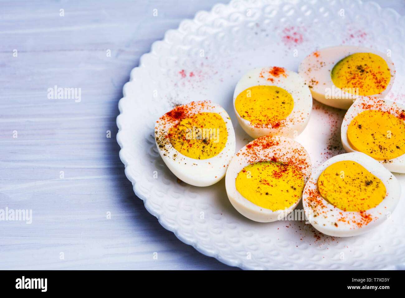 Sliced boiled eggs on a plate top view Stock Photo