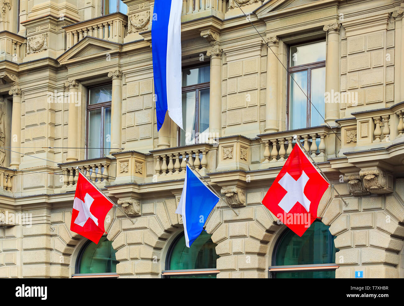 Zurich, Switzerland - August 1, 2016: part of the facade of the Credit Suisse building at Paradeplatz square in the city of Zurich decorated with flag Stock Photo