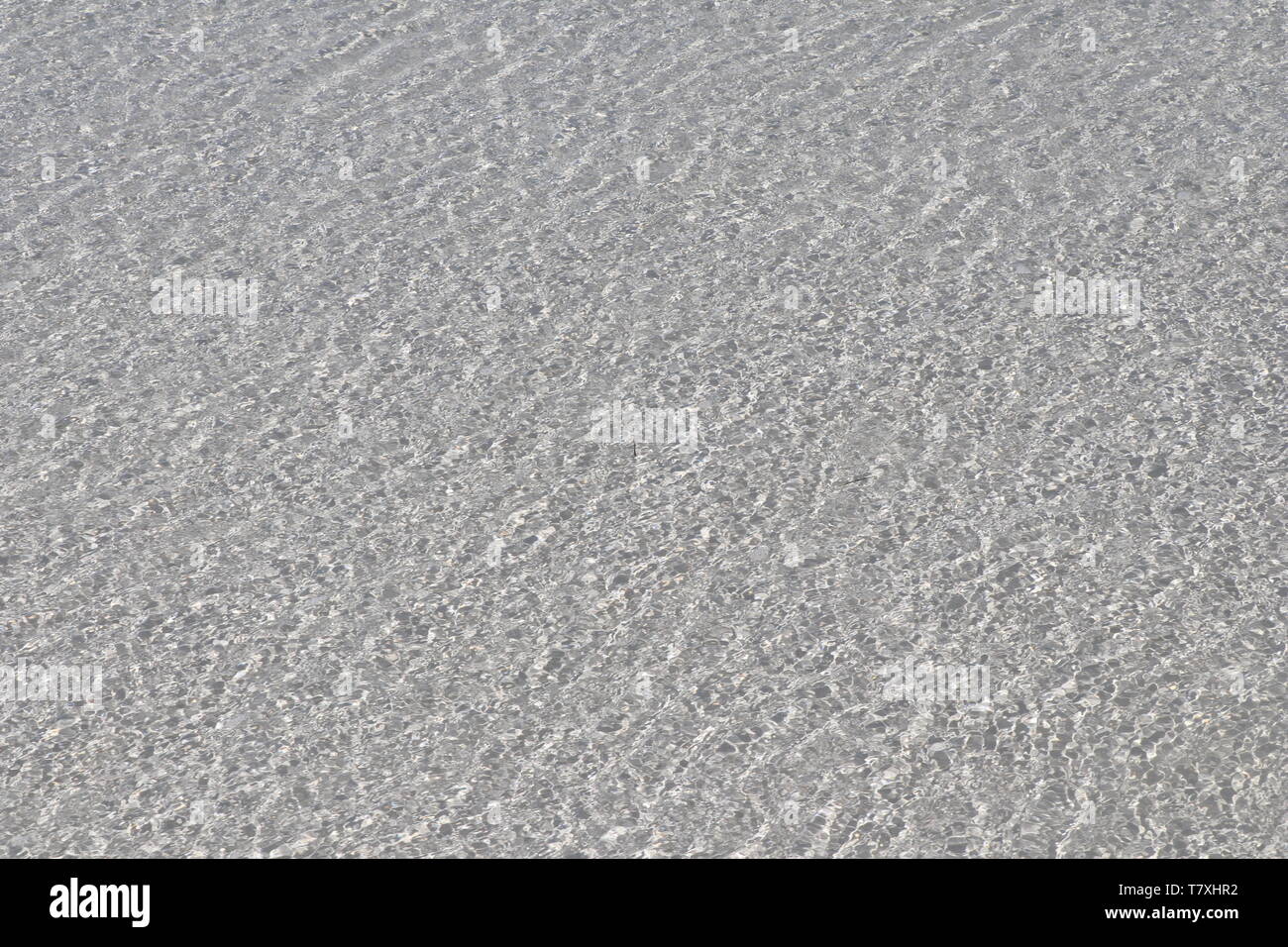 Film of transparent Caribbean water over white sand Stock Photo