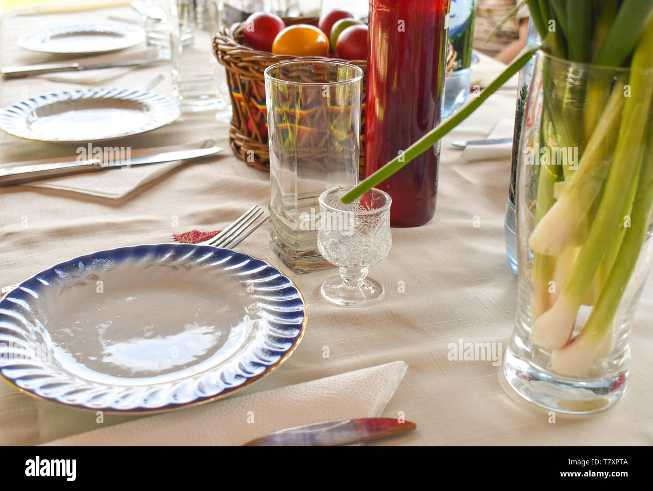 Easter tablewear outdoor under the pergola with colorful eggs in a sunny day Stock Photo