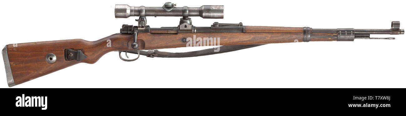 A scope rifle 98 k, Mauser, with high top-hinged mount and scope Dialytan, cal. 8 x 57, no. 42064d. Matching numbers. Mirror-like bore. Code on receiver head covered by front mount base, but various acceptance marks eagle/"135". According to serial number manufactured after 1944 at Mauser-Werke AG, Oberndorf. Sheet steel-stamped magazine plate. Original finish, partially thin and somewhat spotted. Dark laminated stock without external number, not taken apart. Complete with strapping, pitted cleaning rod and front sight guard. Mounted with high to, Additional-Rights-Clearance-Info-Not-Available Stock Photo