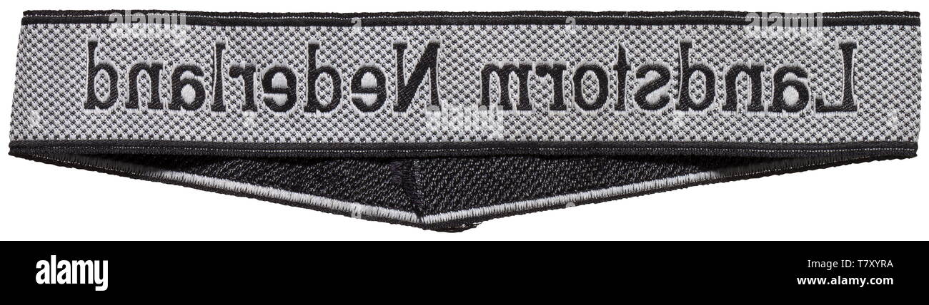 A sleeveband 'Landstorm Nederland' for enlisted men/NCOs of the 34th SS-Freiwilligen-Grenadier-Division. Black and silver-grey woven BeVo type. Unissued. Length 42 cm. historic, historical, 20th century, 1930s, 1940s, secret service, security service, secret services, security services, police, armed service, armed services, NS, National Socialism, Nazism, Third Reich, German Reich, Germany, utensil, piece of equipment, utensils, object, objects, stills, clipping, clippings, cut out, cut-out, cut-outs, fascism, fascistic, National Socialist, Nazi, Nazi period, uniform, unif, Editorial-Use-Only Stock Photo