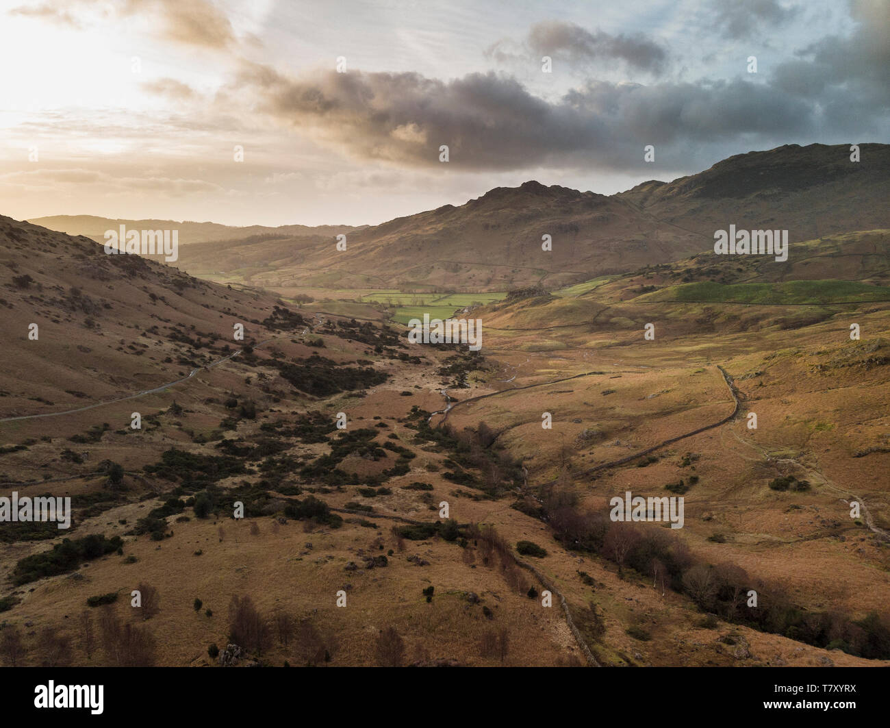 Stunnnig drone aerial sunrise landscape image of Blea Tarn and Langdales Range in UK Lake District Stock Photo