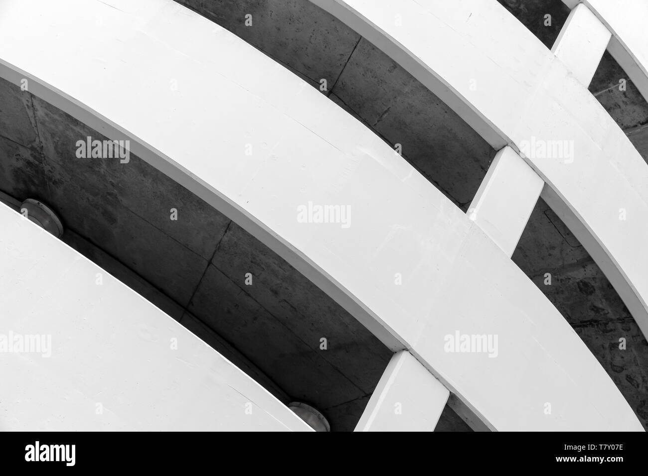 Parking lot, round white concrete building exterior, abstract fragment Stock Photo