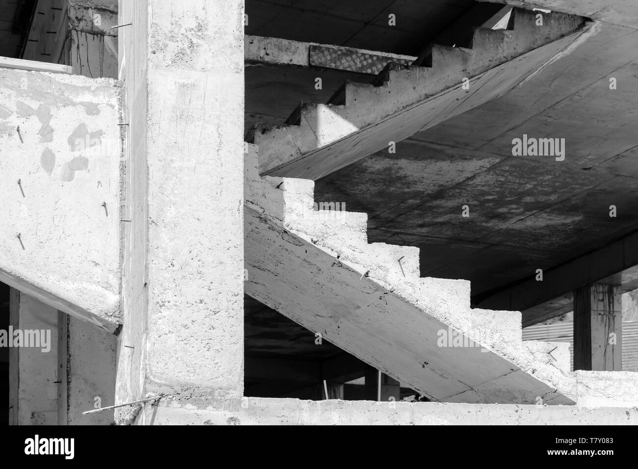 Abstract industrial architecture fragment, white concrete columns and stairs under construction Stock Photo