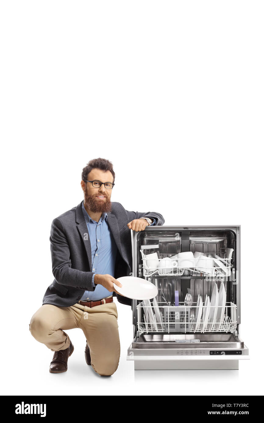 Bearded man putting a plate into a dishwasher isolated on white background Stock Photo Alamy