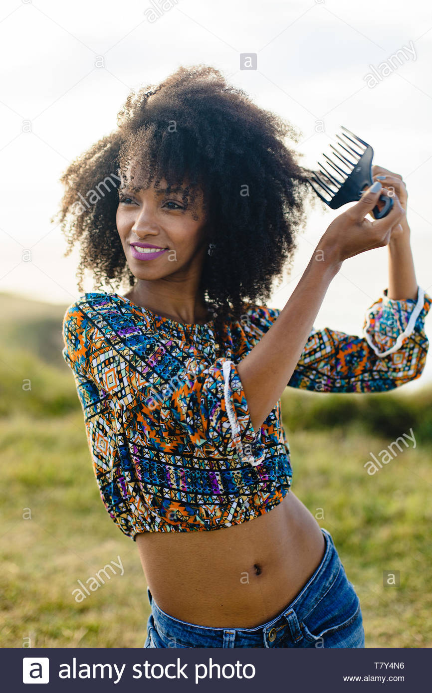 Beautiful Young Woman Using Afro Hair Comb For Styling And