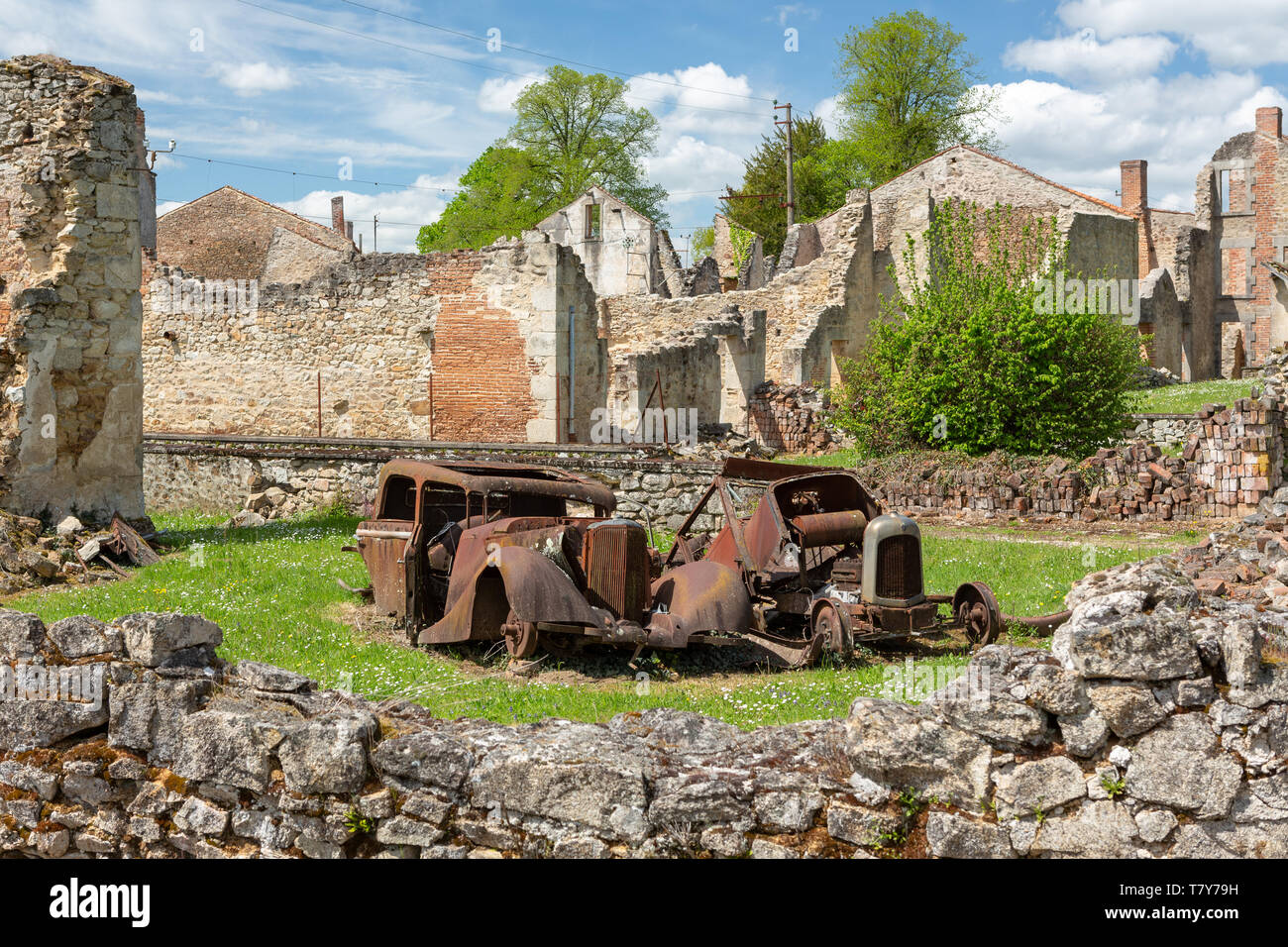 Oradour-sur-Glane, France - April 29, 2019: Old car wrecks in the ruins of the village after the massacre by the german nazi's in 1944 that destroyed  Stock Photo