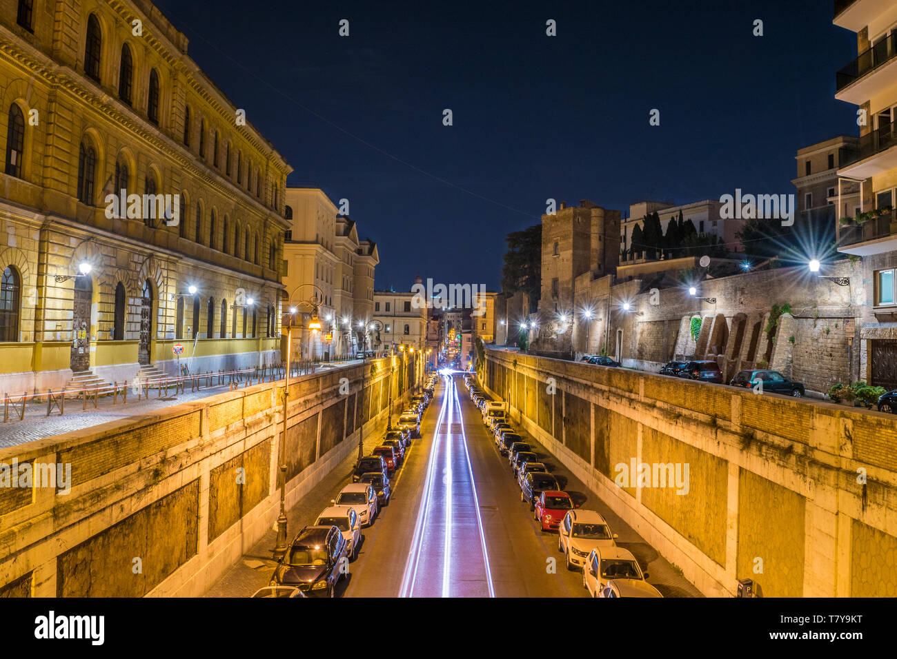 Light tracks of vehicles on Annibaldi street at night in Rome - Italy Stock Photo