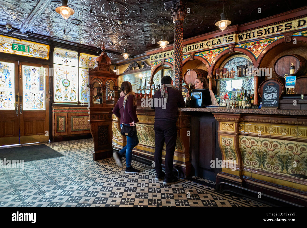 The highly decorated and tiled interior of The Crown public house in Great Victoria Street, Belfast, Northern Ireland Stock Photo