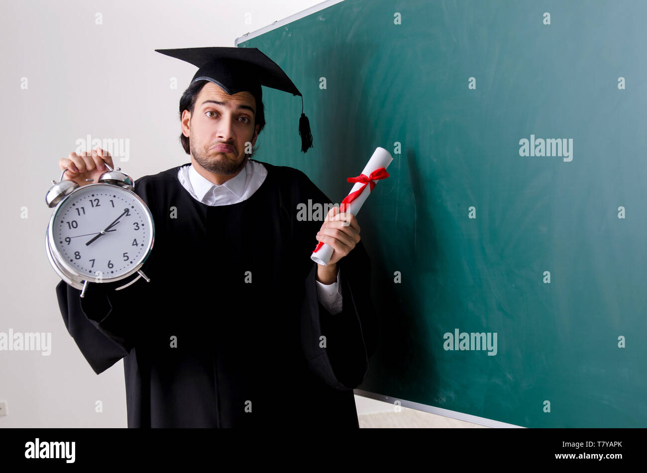 Graduate Board Students Graduate student in front of green board Stock Photo - Alamy