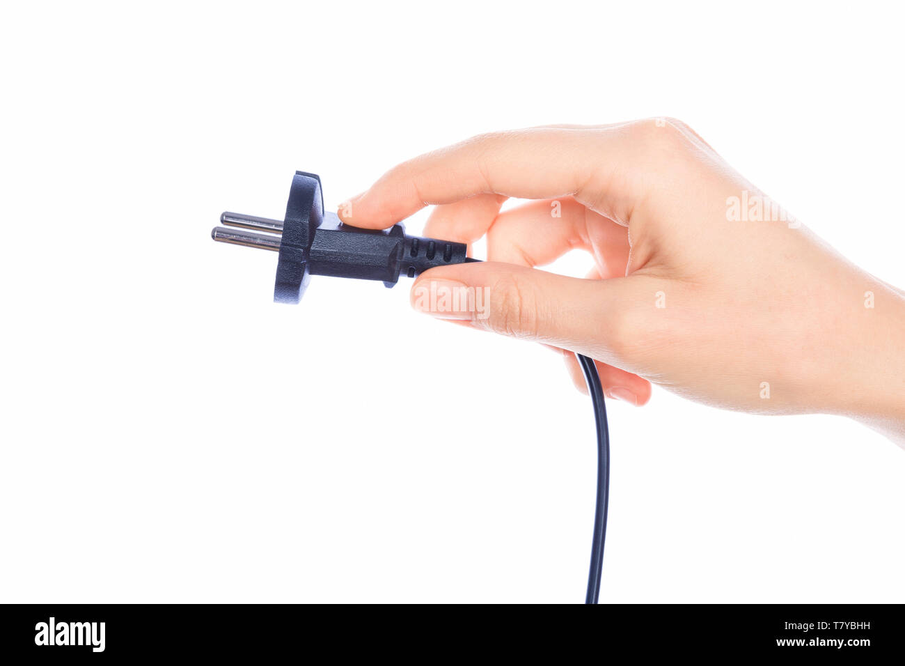 Woman hand holding black male wire plug isolated on white background Stock Photo
