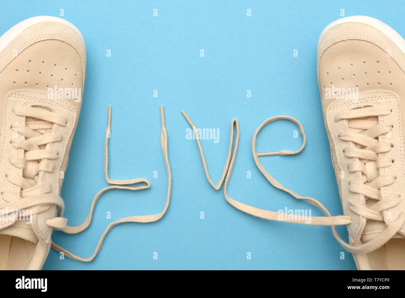 Women sneakers with laces in live text. Stock Photo