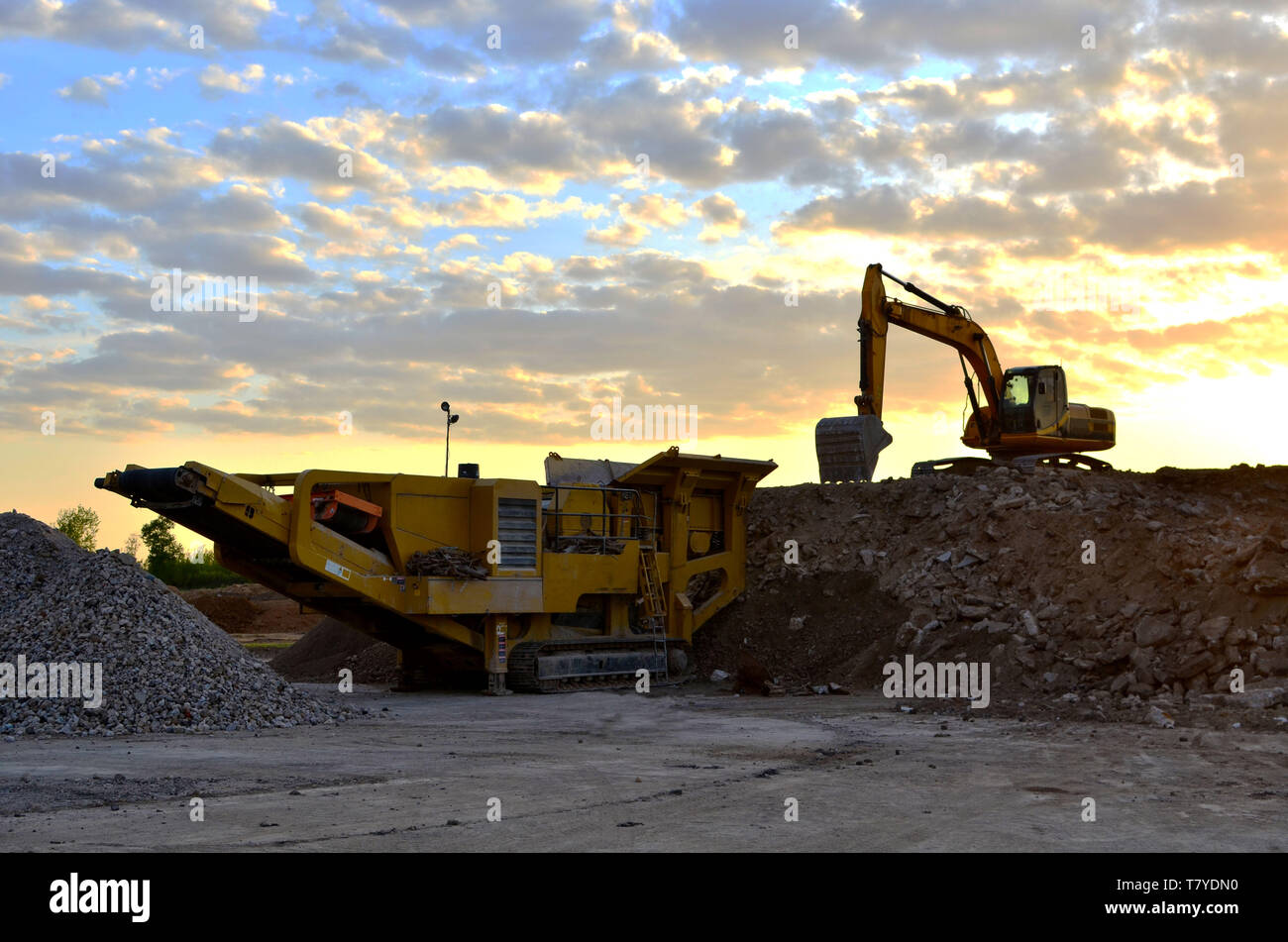 https://c8.alamy.com/comp/T7YDN0/mobile-stone-crusher-machine-by-the-construction-site-or-mining-quarry-for-crushing-old-concrete-slabs-into-gravel-and-subsequent-cement-production-T7YDN0.jpg