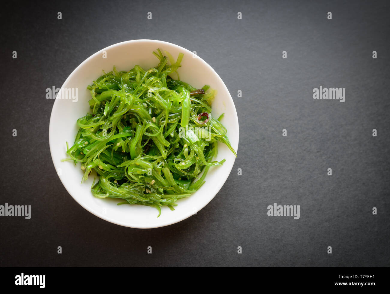 Wakame salad or seaweed salad on dark background. Selective focus. Stock Photo