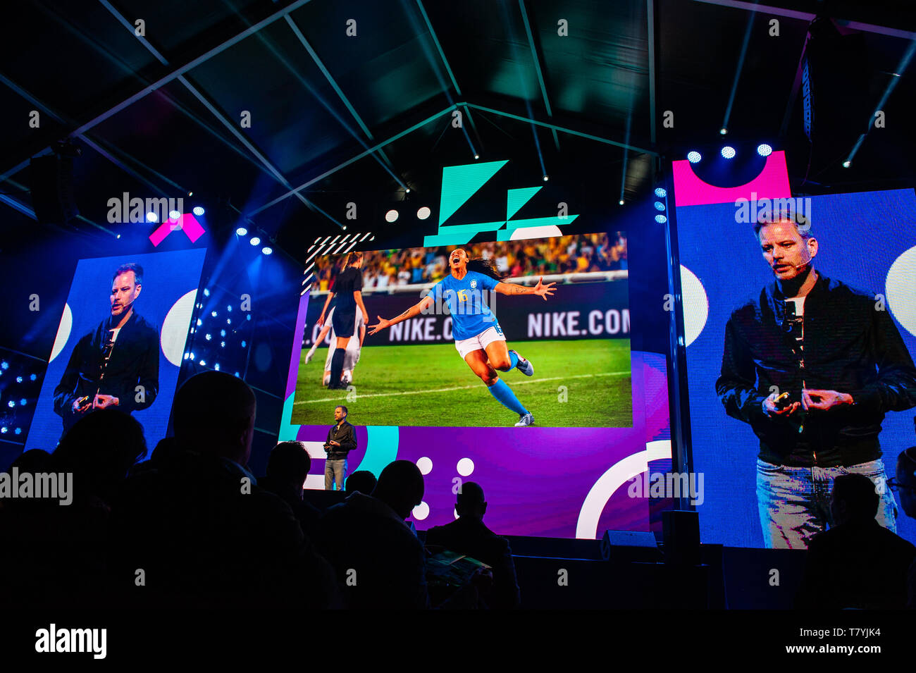 Michael Martin seen speaking while Some images of Nike are seen being  projected during the conference. The 14th edition of the TNW conference was  inaugurated in Amsterdam at the NDSM, a creative