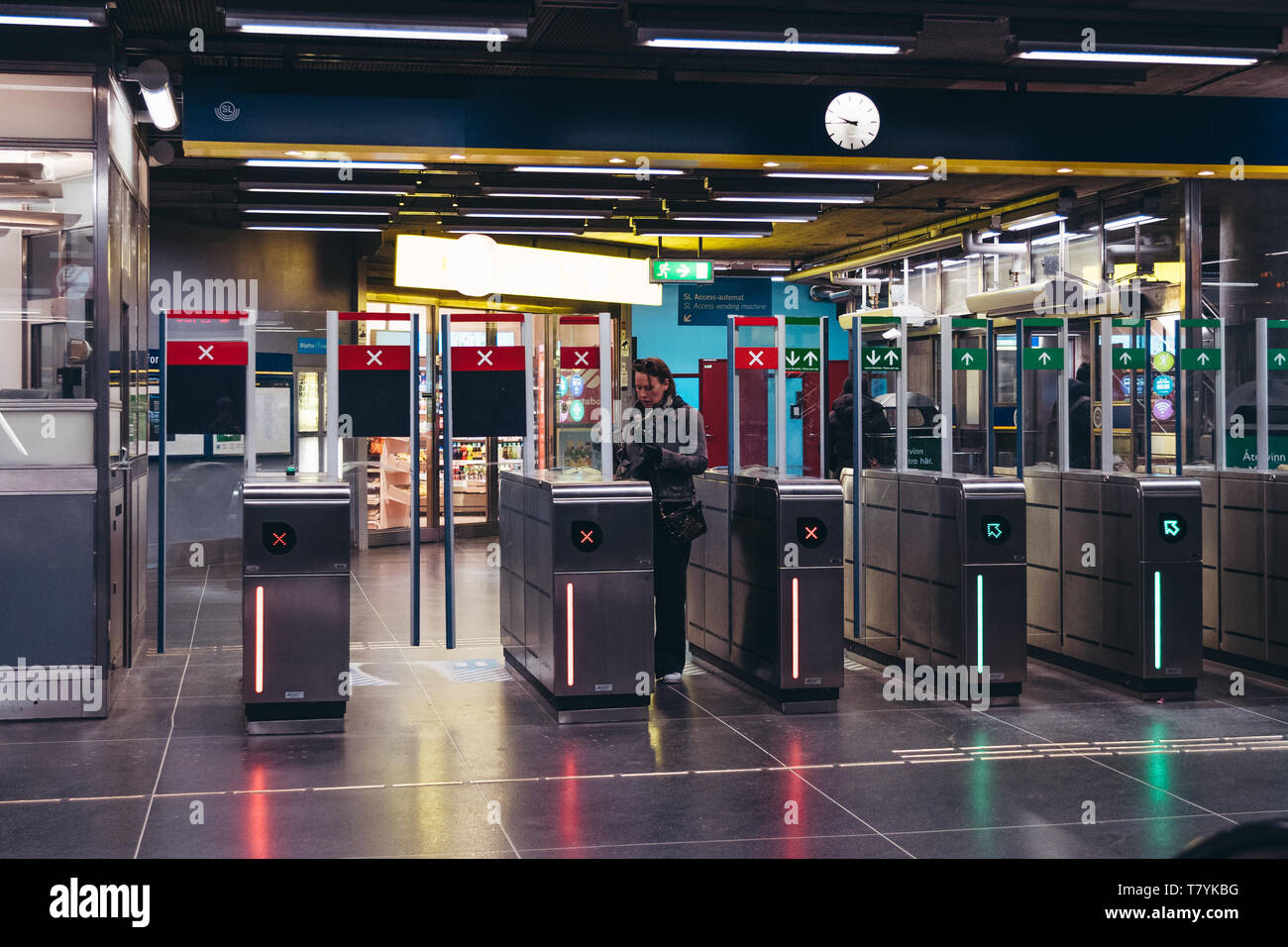 Editorial 03.27.2019 Stockholm Sweden. Woman showing her ticket to the machine and baffle gates at the subway station Stock Photo
