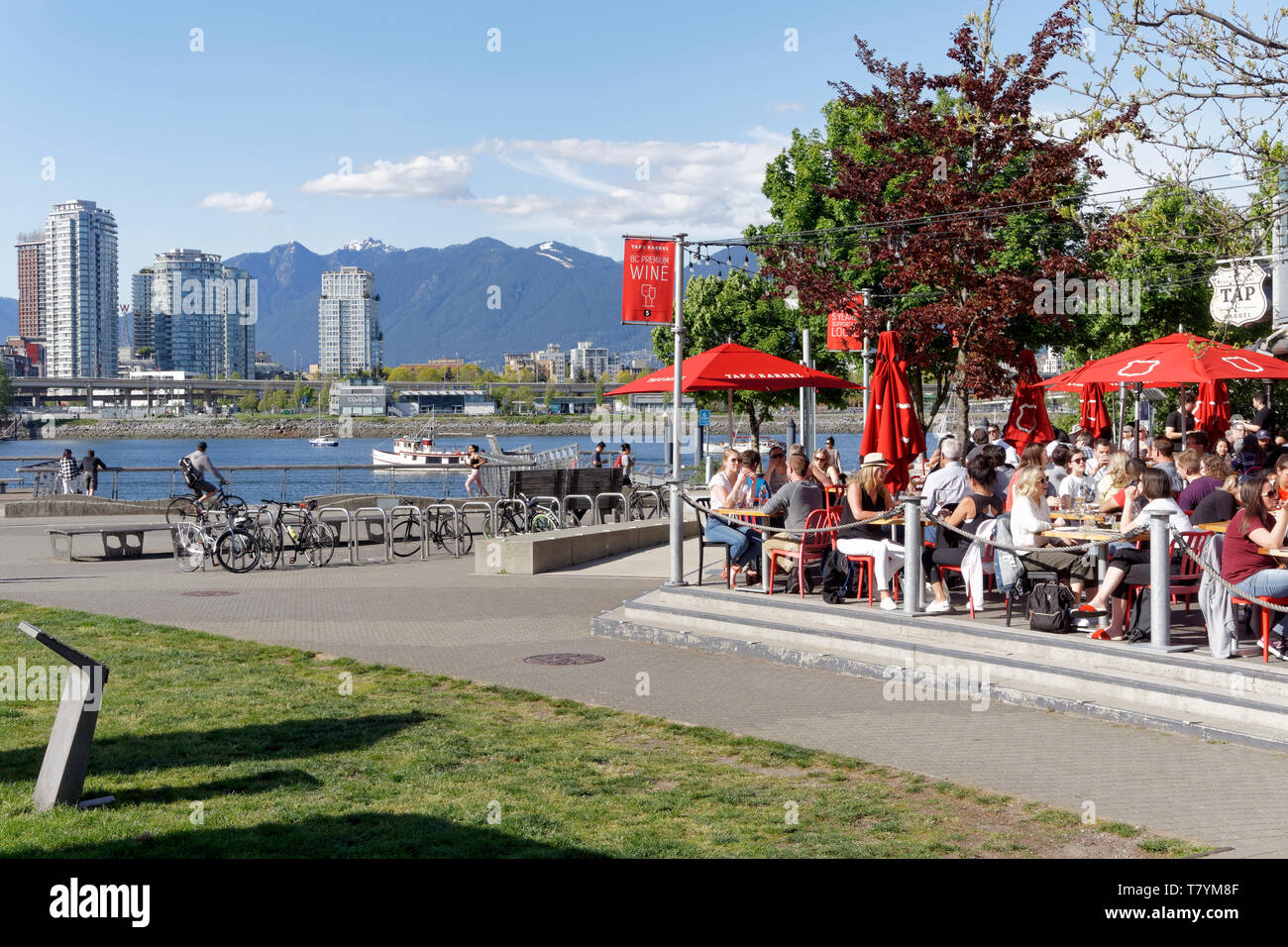 People sitting on the waterfront outdoor patio of Tap and Barrel
