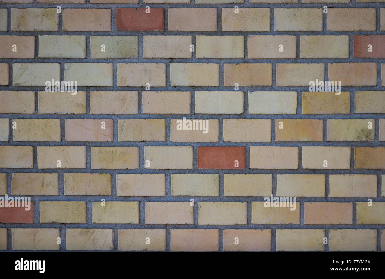 orange red brick wall background with grey grout. Stock Photo