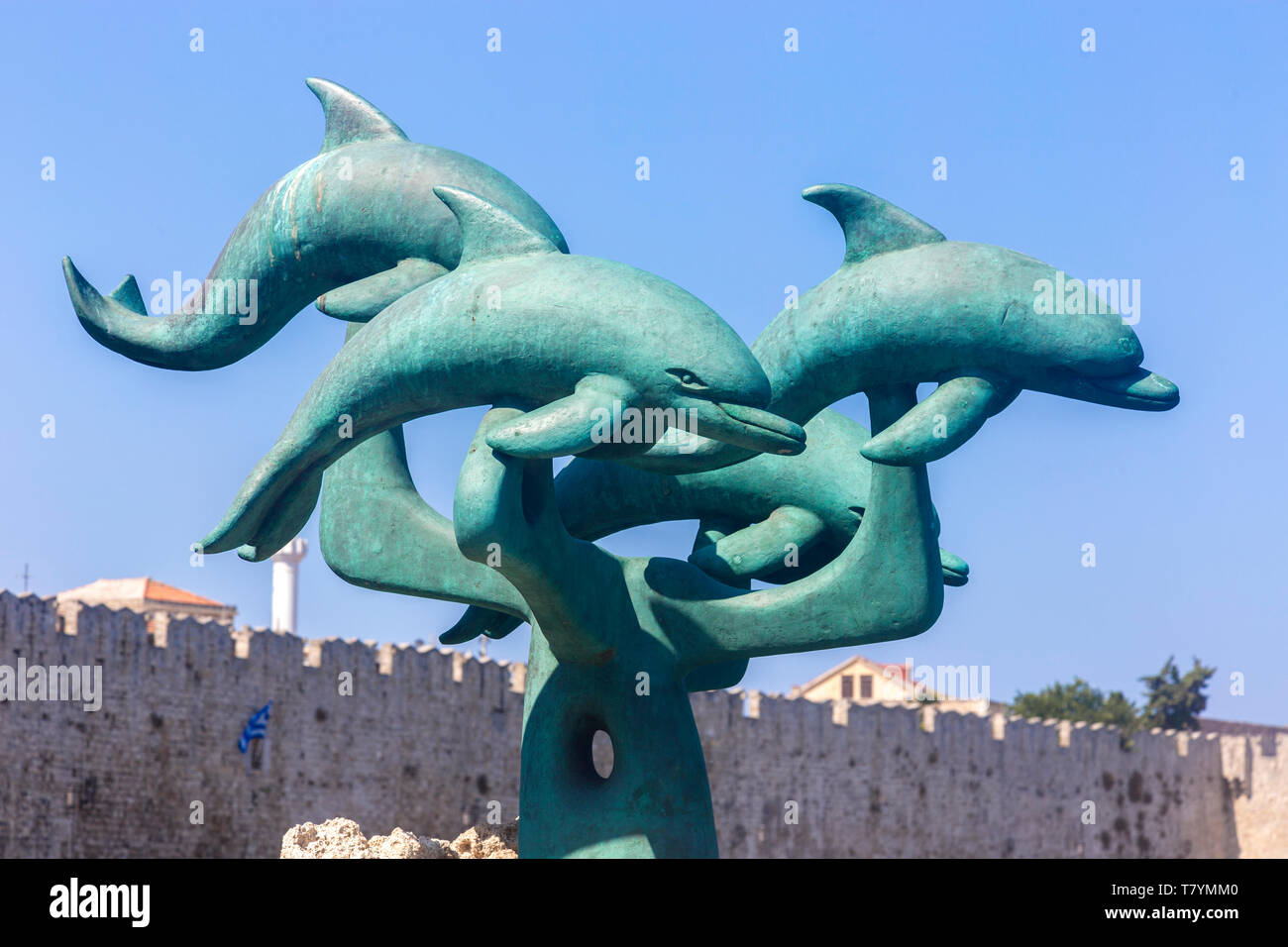 Dolphins in front of the old city of Rhodes, Greece Stock Photo