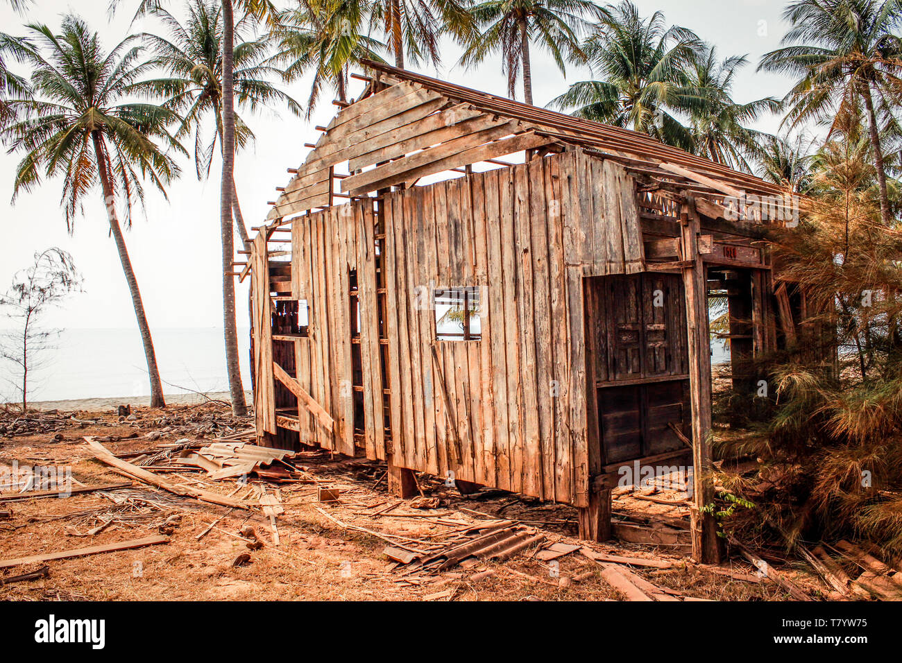 destroyed home at coast , wooden hut ruin / destroyed house made of wood Stock Photo