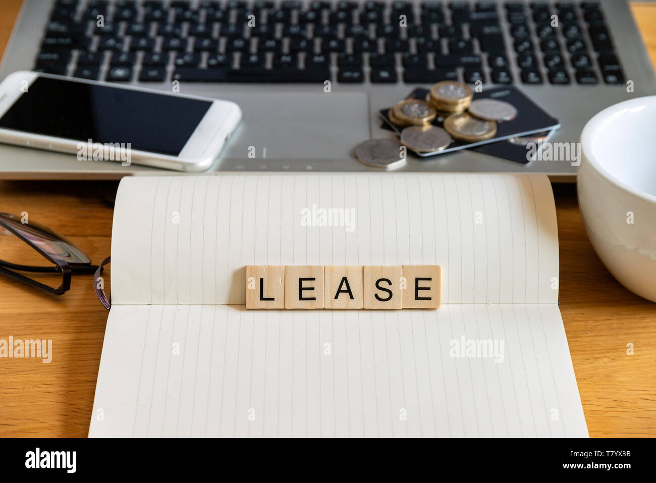 Conceptual keyword lease in generic wooden tile letters in personal ...