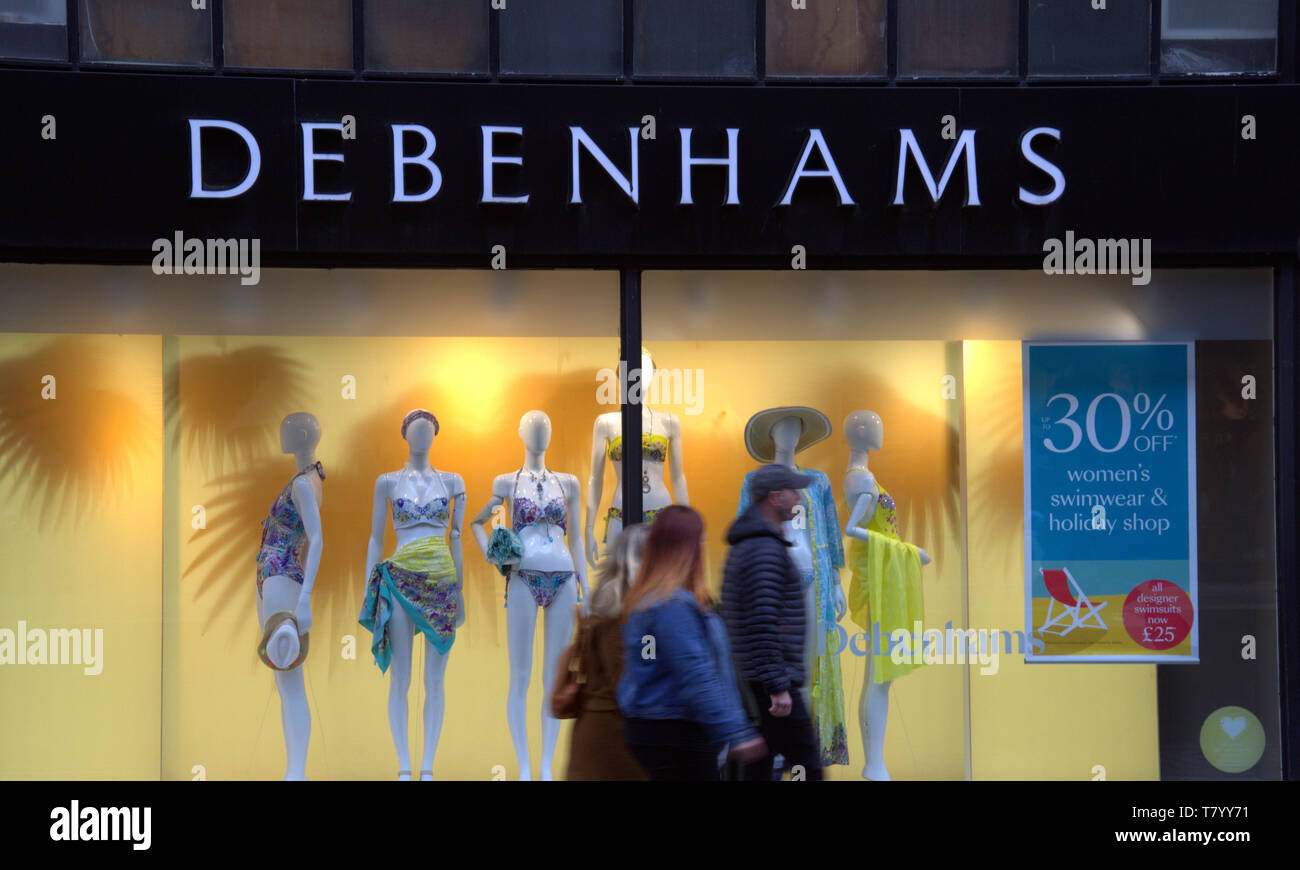 Shop window of Debenhams Department Store, Market Street, Manchester, uk, with passers-by in foreground Stock Photo