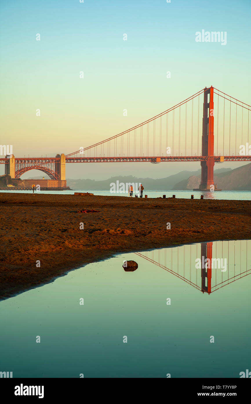 Golden Gate Bridge reflected in pond (in Crissy Field) and people, San Francisco, California USA Stock Photo