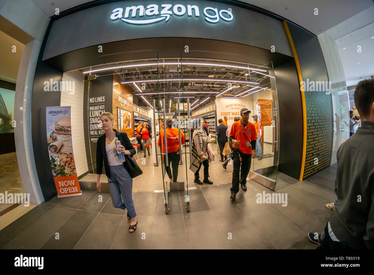 Excited customers shop at the Amazon Go store in the Brookfield Place mall in New York on its grand opening day, Tuesday, May 7, 2019. The 1300 square-foot store, mostly stocked with prepared foods and staples, enables a shopper with the Amazon Go app to just pick up an item and walk out with Amazon â€œtrackingâ€ your purchase and charging you. In a twist from other Amazon Go stores, this one accepts cash also, after facing progressive criticism. (Â© Richard B. Levine) Stock Photo