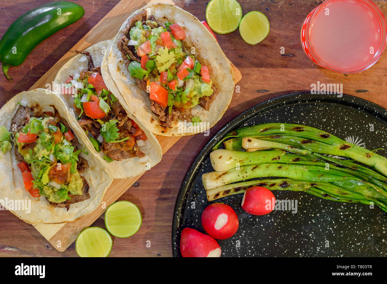 Tijuana tacos, grilled carne asada with radishes, limes, spring onions