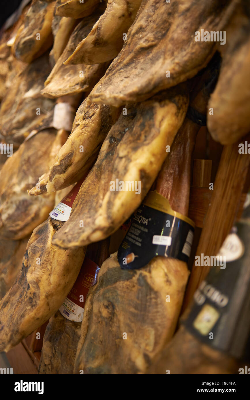 Dried cured meat hanging on a wall Stock Photo