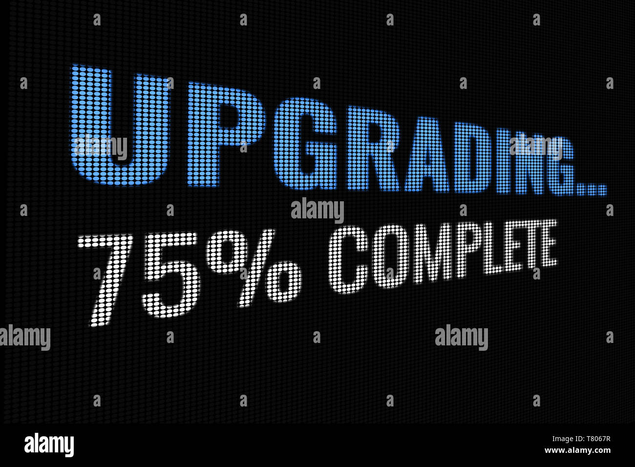 Upgrading 75% complete word on dark screen, tv effect. Stock Photo