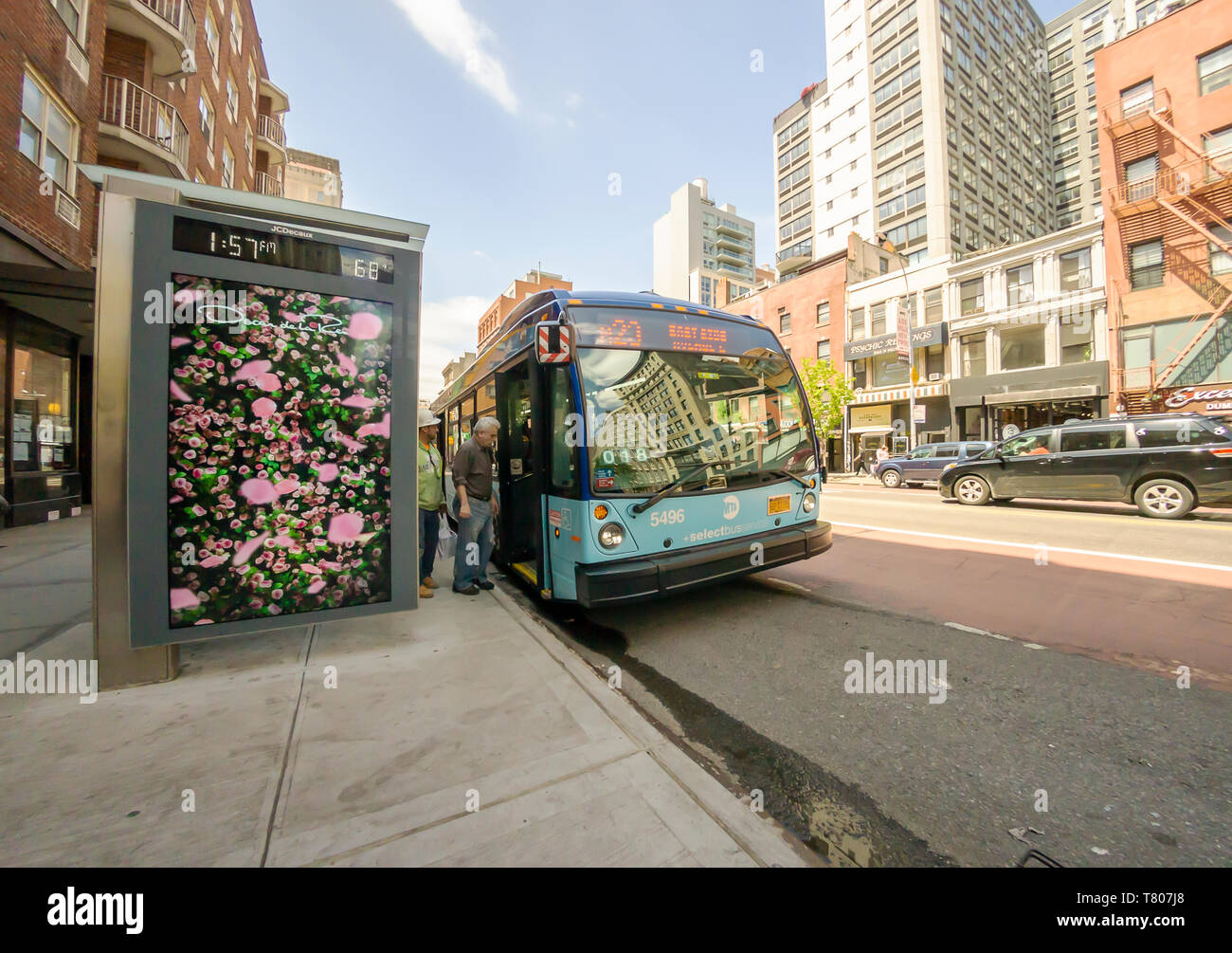 Commuters board an M23 Select Bus in the Chelsea neighborhood of New York on Monday, May 6, 2019. (© Richard B. Levine) Stock Photo