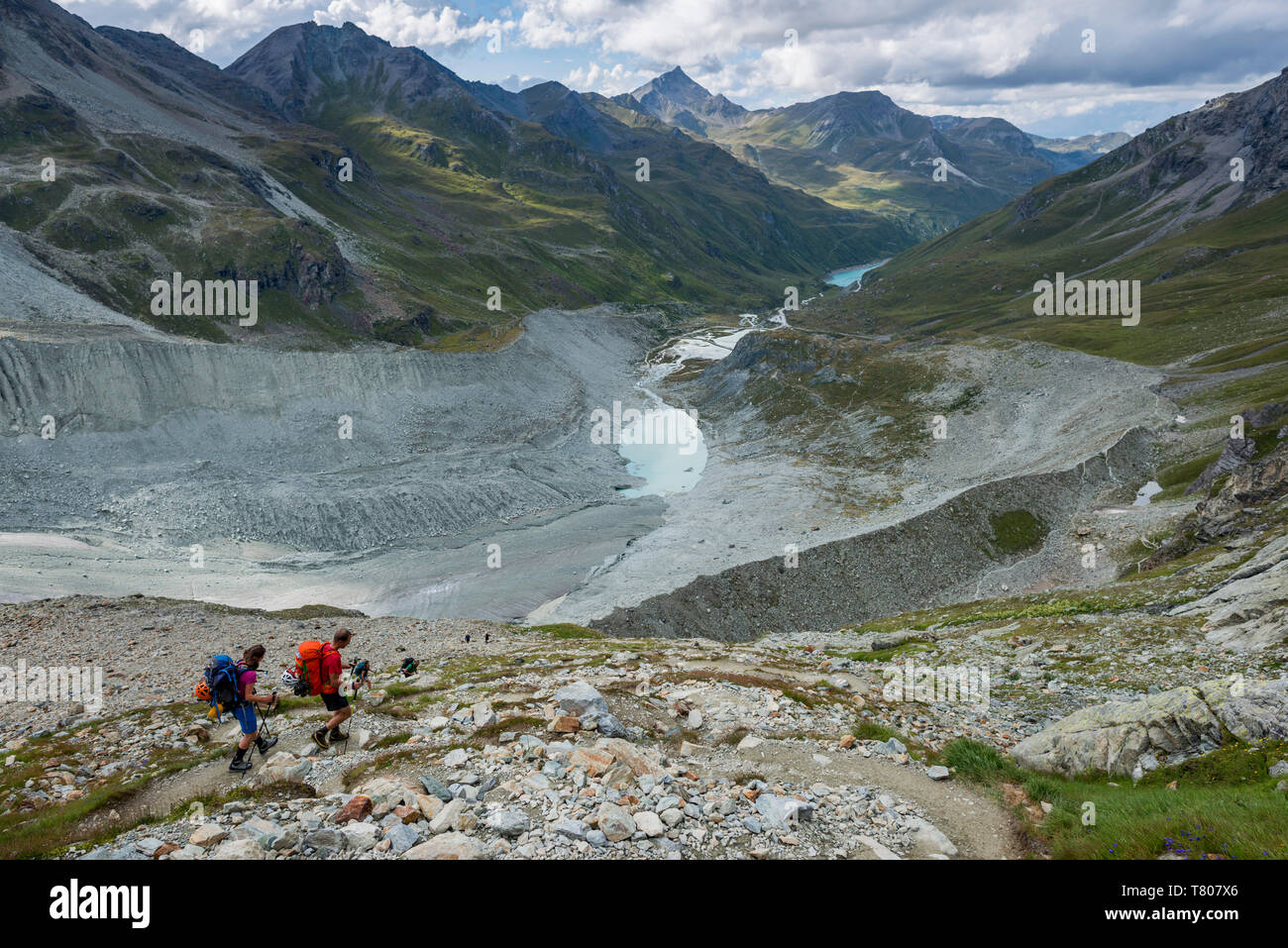 Hikers beside the Moiry Glacier on the Walkers Haute Route from Chamonix to Zermatt, Swiss Alps, Valais, Switzerland, Europe Stock Photo