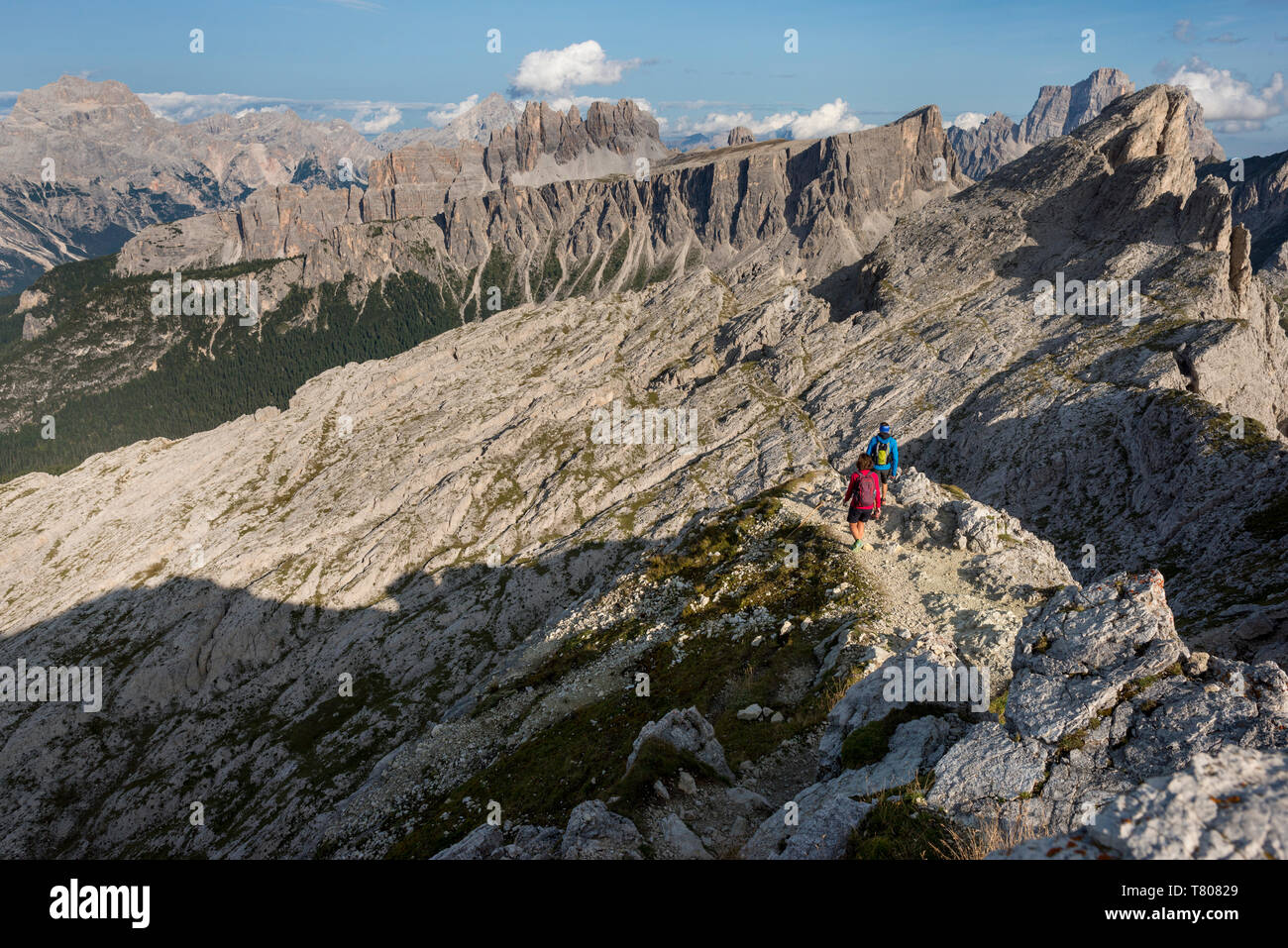 Hiking in typical mountainous terrain of the Dolomites range of the Alps on the Alta Via 1 trekking route near Rifugio Nuvolau, Belluno, Veneto, Italy Stock Photo
