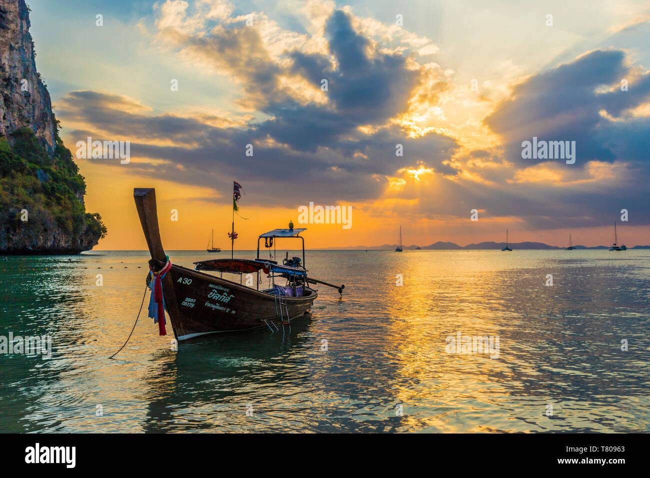 A long tail boat at sunset on Railay beach in Railay, Ao Nang, Krabi Province, Thailand, Southeast Asia, Asia Stock Photo