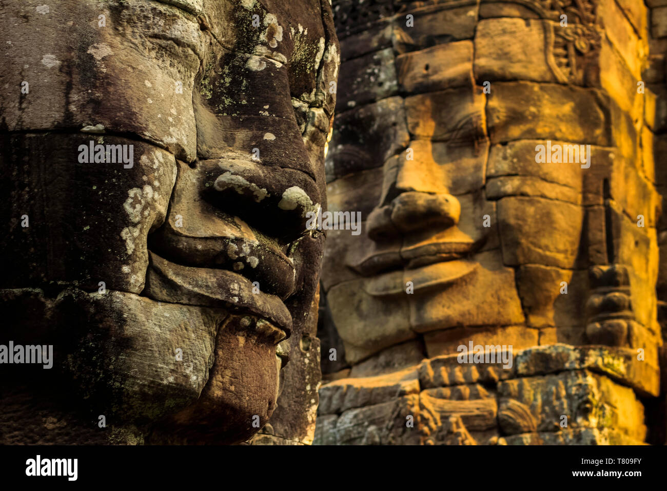 T wo of 216 smiling sandstone faces at 12th century Bayon, King Jayavarman VII's last temple in Angkor Thom, Angkor, UNESCO, Siem Reap, Cambodia, Asia Stock Photo