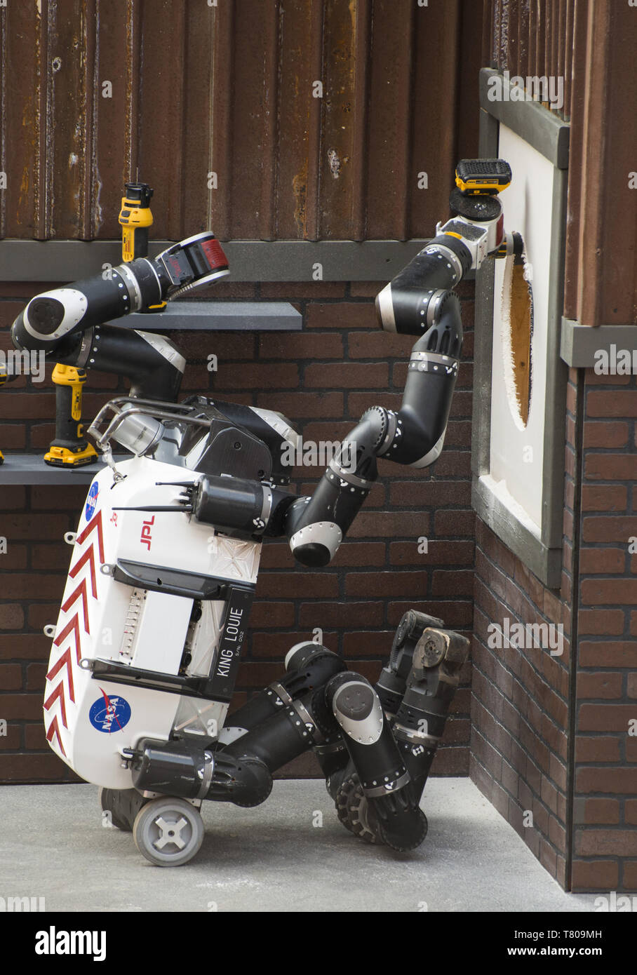 Robot, RoboSimian Using Cordless Power Drill Stock Photo