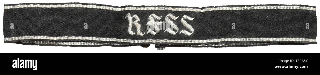 A sleeveband "RFSS" for officers in the personal staff of the Reichsführer-SS in silver-embroidered RZM pattern. Black woven with silver stripes at the borders and silver hand-embroidered name with a textile reinforcement on the reverse. Only remnants of the RZM SS paper tag. Worn. Length 43 cm. historic, historical, 20th century, troop, troops, SS, Schutzstaffel, Editorial-Use-Only Stock Photo