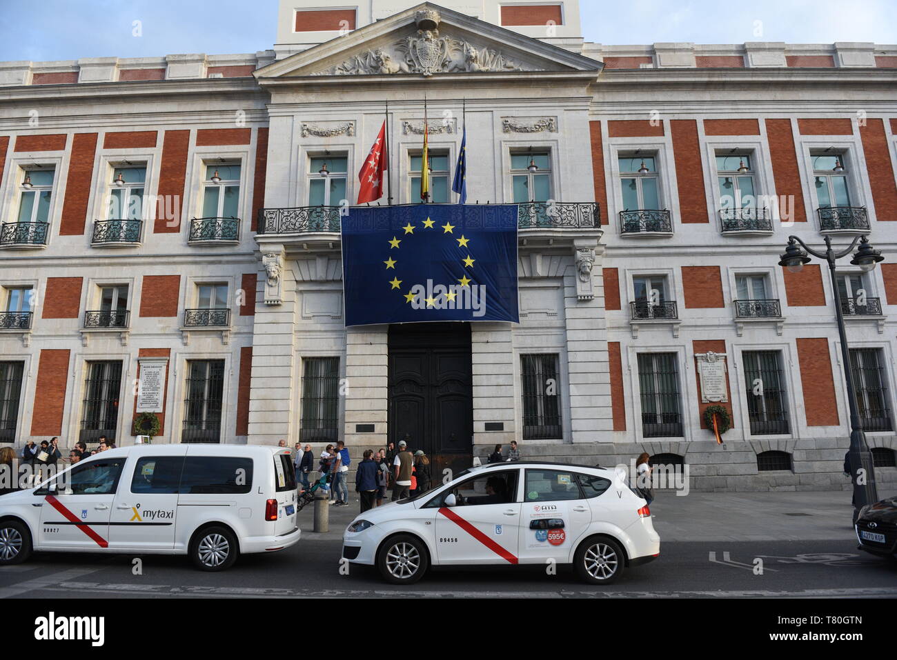 The European Union flag is seen hanging on the Royal Post Office building, seat of the Presidency of the Community of Madrid, during the celebration of Europe Day. Stock Photo