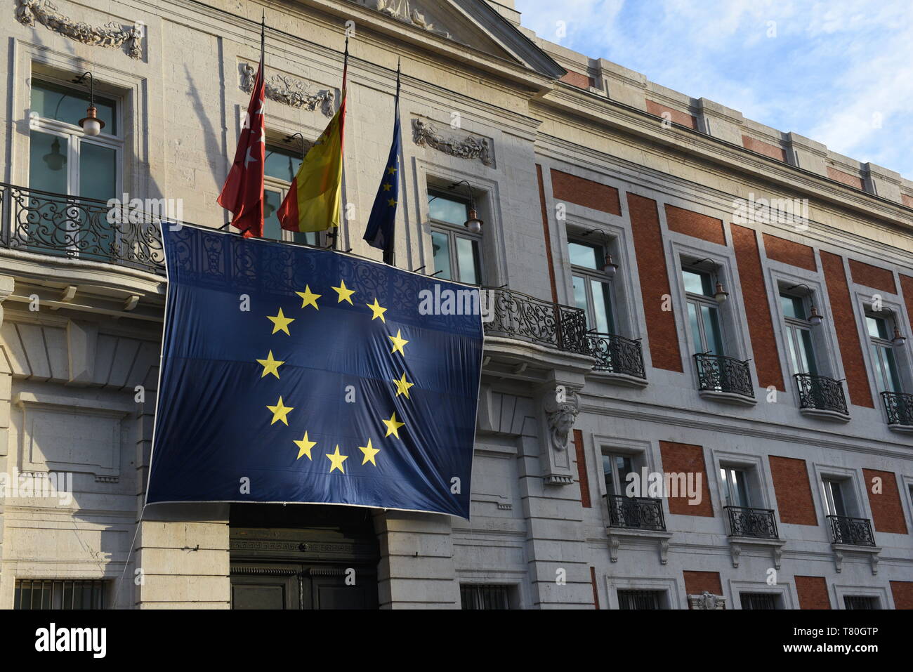 The European Union flag is seen hanging on the Royal Post Office building, seat of the Presidency of the Community of Madrid, during the celebration of Europe Day. Stock Photo