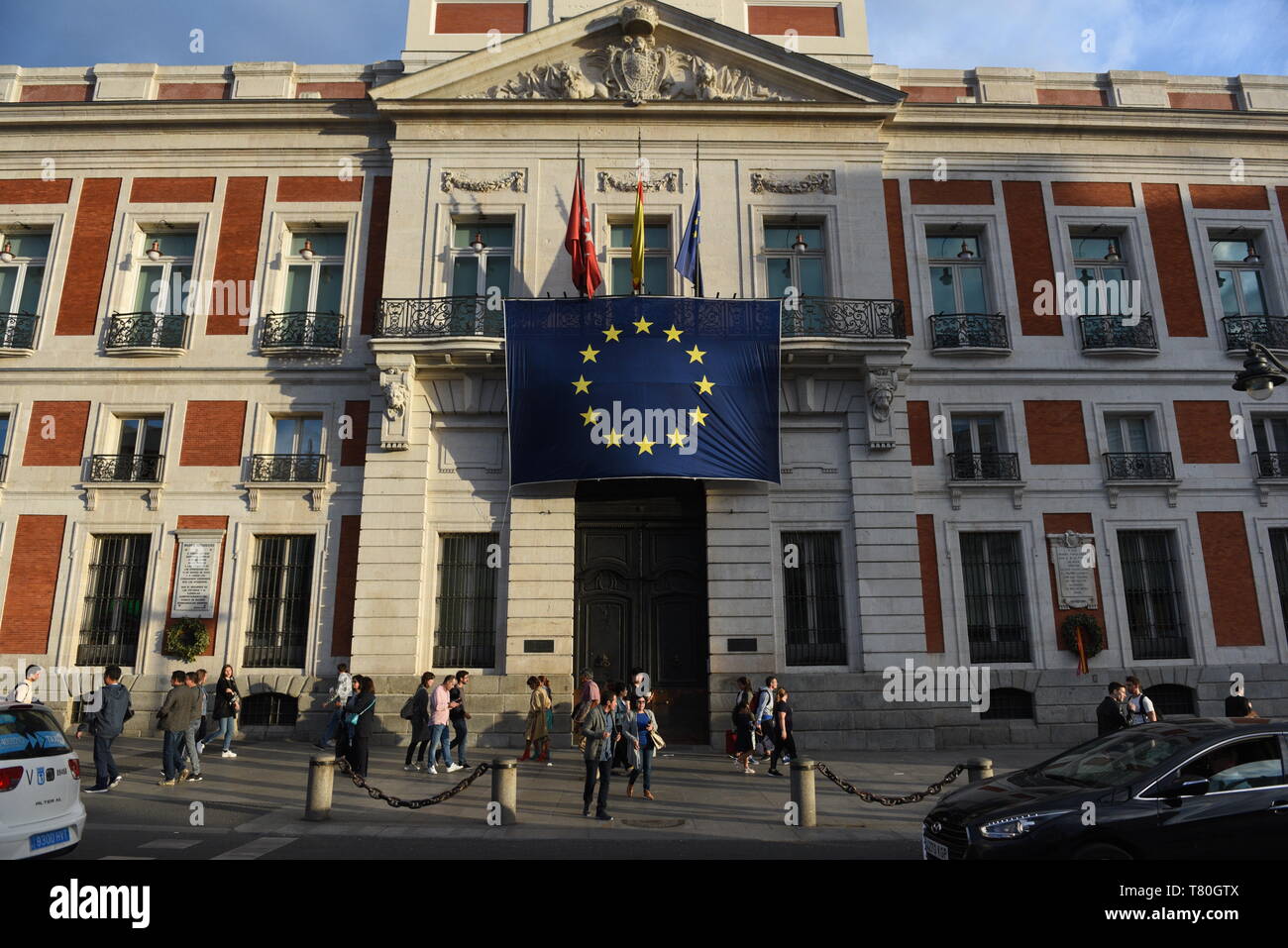 The European Union flag is seen hanging on the Royal Post Office building, seat of the Presidency of the Community of Madrid, during the celebration of Europe Day. Stock Photo